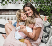 mom holding two sons on lap